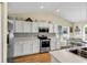 Bright kitchen showcasing white cabinetry, stainless steel appliances, and modern countertops, open to the dining area at 4008 Scarlet Oak Ct., Myrtle Beach, SC 29579