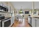 Open-concept kitchen featuring white cabinetry, stainless steel appliances, and seamless access to the dining area at 4008 Scarlet Oak Ct., Myrtle Beach, SC 29579