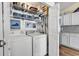 Functional laundry room with modern washer and dryer units, built-in shelving, and ample storage space at 4008 Scarlet Oak Ct., Myrtle Beach, SC 29579