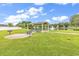 Community picnic area with a gazebo, picnic tables, and BBQ grills, located next to a serene pond with a fountain at 4008 Scarlet Oak Ct., Myrtle Beach, SC 29579