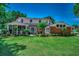 Expansive backyard featuring large lawn, brick home, screened in porch, and manicured flowerbeds at 402 E Broad St., Hemingway, SC 29554