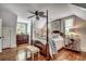 Traditional primary bedroom with four-poster bed, hardwood floors, and bright natural light at 402 E Broad St., Hemingway, SC 29554