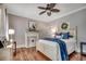 Cozy bedroom boasts wood floors, fireplace, and stylish decor, offering a relaxing retreat at 402 E Broad St., Hemingway, SC 29554