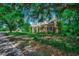 Charming two-story brick home with classic design, mature trees, and well-manicured lawn at 402 E Broad St., Hemingway, SC 29554