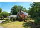 Beautiful brick home with manicured lawn, colorful flowerbeds, and mature trees at 402 E Broad St., Hemingway, SC 29554