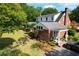 Expansive yard with well-maintained landscaping and a brick home with a rear entrance and grey roof at 402 E Broad St., Hemingway, SC 29554