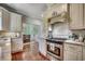 Modern kitchen with a stainless steel oven, refrigerator, granite countertop, and custom white cabinets at 402 E Broad St., Hemingway, SC 29554