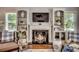 Inviting living room features a fireplace flanked by built-in shelves and a wall-mounted television at 402 E Broad St., Hemingway, SC 29554