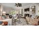 Well-decorated living room features a fireplace, built-in shelves, plush seating, and access to the outdoor area at 402 E Broad St., Hemingway, SC 29554