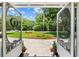 View of front yard, garden, and flagpole seen through decorative screen doors at 4023 Murrells Inlet Rd., Murrells Inlet, SC 29576
