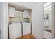 Laundry room with full-size white washer and dryer, and bright cabinets for storage at 4023 Murrells Inlet Rd., Murrells Inlet, SC 29576