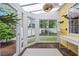 Bright sunroom with brick flooring, large windows, and a playful cat climbing tree feature at 4023 Murrells Inlet Rd., Murrells Inlet, SC 29576