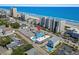 Aerial view of a beach house with a pool near the ocean and surrounding condos at 4206 S Ocean Blvd., North Myrtle Beach, SC 29582