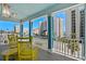 Relaxing covered balcony with bright yellow rocking chairs and scenic city views at 4206 S Ocean Blvd., North Myrtle Beach, SC 29582