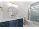 Modern bathroom featuring a blue vanity, gold fixtures, and a glass-enclosed shower at 4206 S Ocean Blvd., North Myrtle Beach, SC 29582
