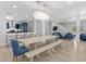 Open-concept dining area with modern table, chandelier and an open view into the kitchen at 4206 S Ocean Blvd., North Myrtle Beach, SC 29582