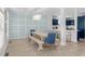 Elegant dining room with modern light fixture and an open view into the kitchen at 4206 S Ocean Blvd., North Myrtle Beach, SC 29582
