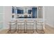 Bright kitchen with white counters, bar seating, and blue cabinets with stainless appliances at 4206 S Ocean Blvd., North Myrtle Beach, SC 29582