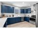 Kitchen with white counters, white backsplash, stainless appliances, and blue cabinets at 4206 S Ocean Blvd., North Myrtle Beach, SC 29582