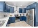 Kitchen with white counters, white backsplash, stainless appliances, and blue cabinets at 4206 S Ocean Blvd., North Myrtle Beach, SC 29582