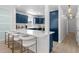 Kitchen with bar seating, white counters, blue cabinets and stainless appliances at 4206 S Ocean Blvd., North Myrtle Beach, SC 29582