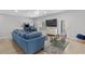Inviting living room featuring plush blue seating, an arcade game, and a sliding glass door at 4206 S Ocean Blvd., North Myrtle Beach, SC 29582