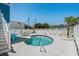 Outdoor pool with lounge chairs and seating area surrounded by white fence at 4206 S Ocean Blvd., North Myrtle Beach, SC 29582