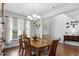 Sunlit dining room features a stylish chandelier, hardwood floors, and ample seating for Gathering and guests at 4246 Livorn Loop, Myrtle Beach, SC 29579