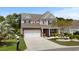 Two-story home boasts a well-manicured lawn, brick accents, and a convenient two-car garage at 4246 Livorn Loop, Myrtle Beach, SC 29579