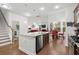 Open-concept kitchen with stainless steel appliances, an island, and views of the dining and living areas at 4246 Livorn Loop, Myrtle Beach, SC 29579