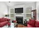 Cozy living room features a fireplace, large TV, and comfortable seating with plenty of natural light at 4246 Livorn Loop, Myrtle Beach, SC 29579