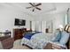 Comfortable main bedroom with tray ceilings, a ceiling fan, and an en-suite bathroom at 4246 Livorn Loop, Myrtle Beach, SC 29579