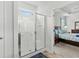 Clean shower with white tiled walls and glass door and access to the main bedroom at 4246 Livorn Loop, Myrtle Beach, SC 29579