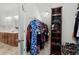 Spacious walk-in closet features ample storage and an organization system for clothes and accessories plus a bathroom nearby at 4246 Livorn Loop, Myrtle Beach, SC 29579
