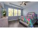 Bedroom featuring lots of light from three windows, wood-look floors, and a colorful bedspread at 428 Calhoun Falls Dr., Myrtle Beach, SC 29579