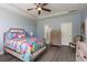 Bright bedroom featuring a ceiling fan, wood-look floors, and a colorful bedspread at 428 Calhoun Falls Dr., Myrtle Beach, SC 29579