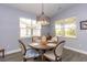 Dining room featuring a chandelier, round wood table, and seating for four at 428 Calhoun Falls Dr., Myrtle Beach, SC 29579