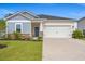 Charming single-Gathering home with a two-car garage, well-manicured lawn, and stone accents at 4609 Day Lily Run St., Myrtle Beach, SC 29579