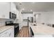 Modern kitchen with white cabinets, stainless steel appliances, granite countertops, and stylish backsplash at 4609 Day Lily Run St., Myrtle Beach, SC 29579