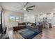 Open-concept living room featuring a plush sectional sofa, ceiling fan, and wood-look flooring at 4609 Day Lily Run St., Myrtle Beach, SC 29579