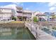 Waterfront backyard featuring a private dock, lush lawn, and outdoor seating under the house at 48 Sw Wilmington St., Ocean Isle Beach, NC 28469