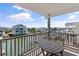 Balcony overlooking calm water, featuring a table and chairs for outdoor relaxation and scenic enjoyment at 48 Sw Wilmington St., Ocean Isle Beach, NC 28469
