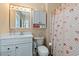 Cozy bathroom showcasing white cabinets, decorative seashell curtain and vanity mirror at 48 Sw Wilmington St., Ocean Isle Beach, NC 28469