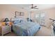 Relaxing bedroom showcasing a bed with blue patterned linens and direct patio access at 48 Sw Wilmington St., Ocean Isle Beach, NC 28469