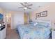 Bright bedroom with a ceiling fan, white wicker furniture, and view to the ensuite bathroom at 48 Sw Wilmington St., Ocean Isle Beach, NC 28469