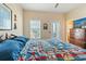 Bedroom with a quilt-covered bed, dresser, and view of the outdoors at 48 Sw Wilmington St., Ocean Isle Beach, NC 28469