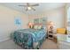 Calm bedroom with a bed decorated in seashell patterns, complemented by a ceiling fan and side tables at 48 Sw Wilmington St., Ocean Isle Beach, NC 28469