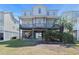 Three story beach house with covered decks, ground floor parking, and easy beach access at 48 Sw Wilmington St., Ocean Isle Beach, NC 28469