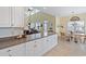 Open concept living area with white cabinets, bar seating, and a view to the dining area at 48 Sw Wilmington St., Ocean Isle Beach, NC 28469