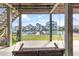 Covered porch showcasing a swing overlooking a canal and waterfront homes at 48 Sw Wilmington St., Ocean Isle Beach, NC 28469
